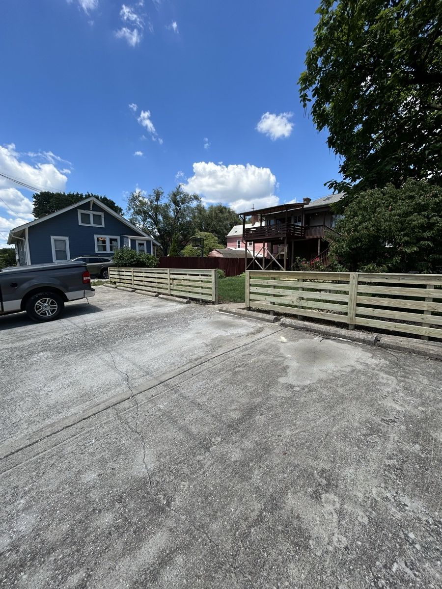 Horizontal timber fence beside a residential driveway